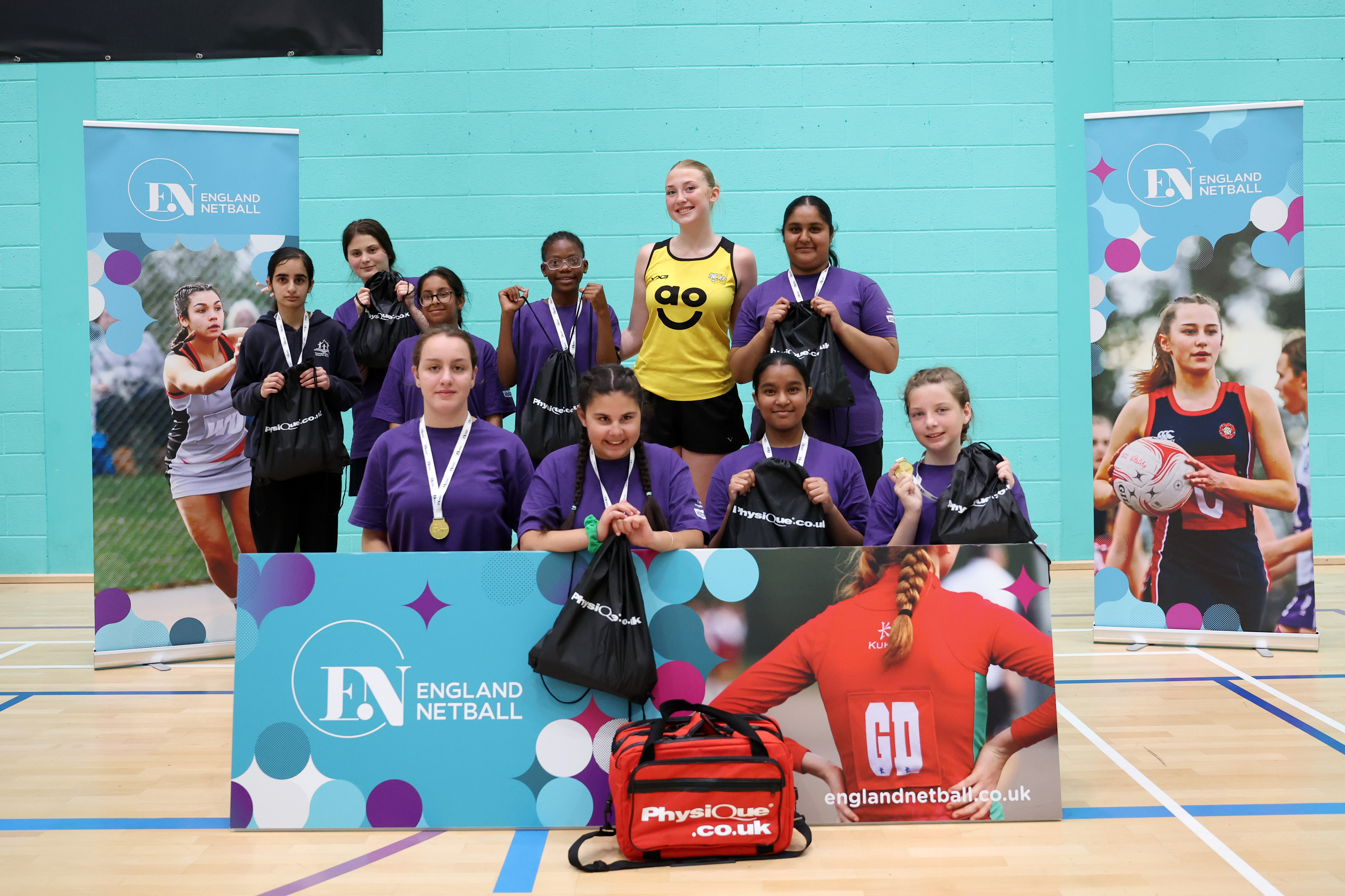 A group photo featuring Manchester Thunder's Shannon Mahlik with the winning school team from Thomasson Memorial.